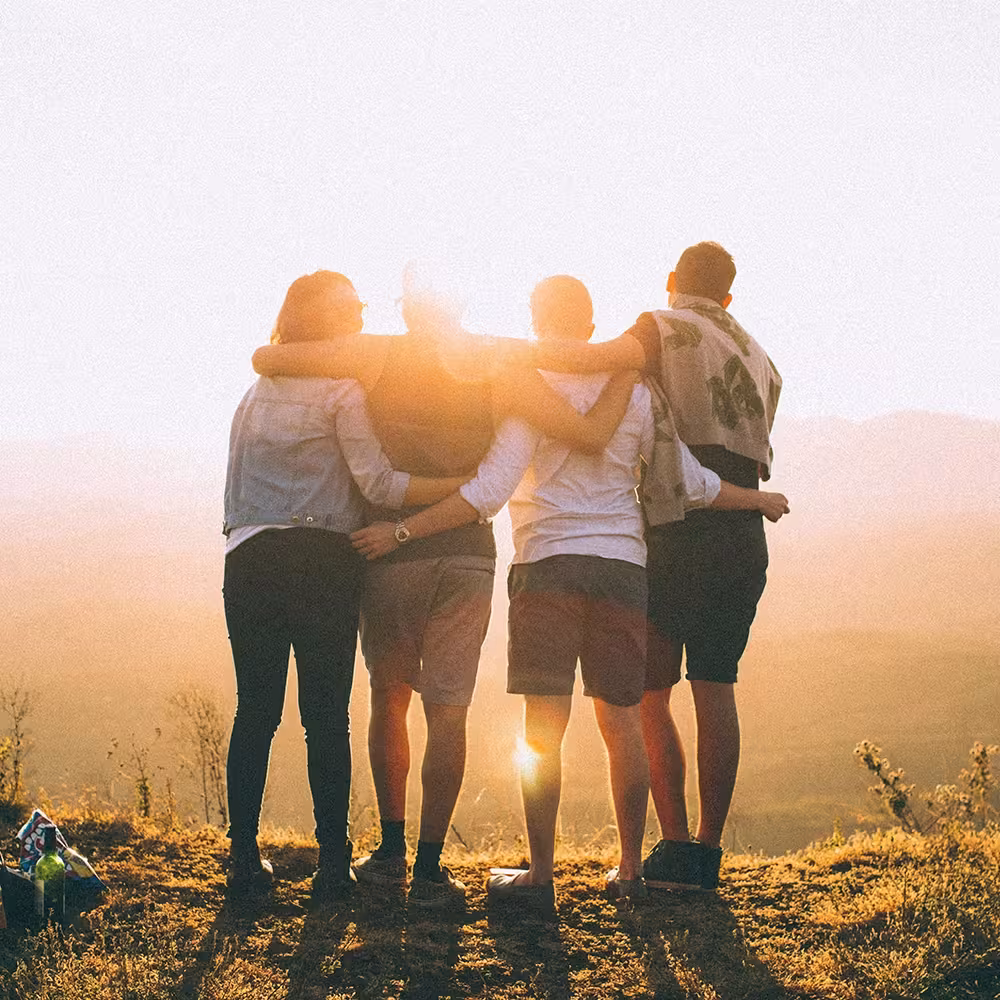 A group of people watching the sunset.